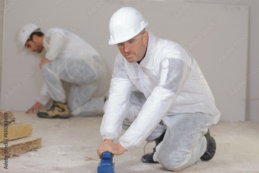 a professional worker sanding floor