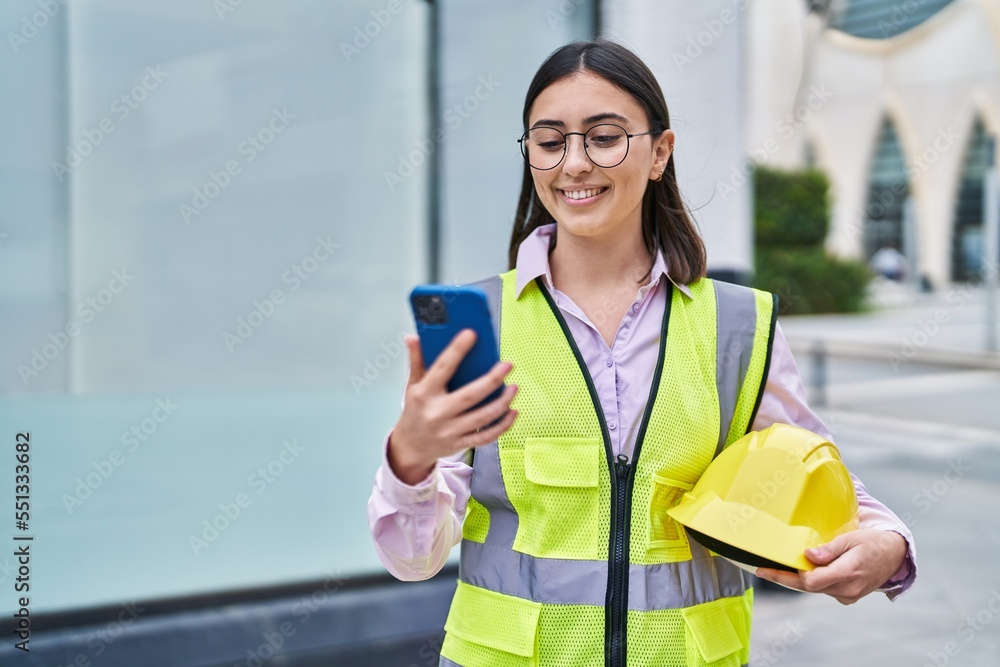 Young hispanic woman architect using smartphone at street Young hispanic woman architect using smartphone at street