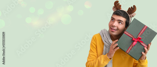 Happy young man holding Chr...