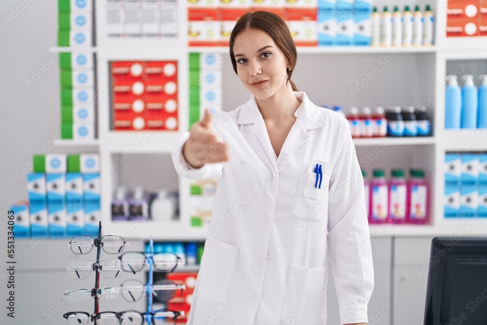 Young woman pharmacist shake hand at pharmacy