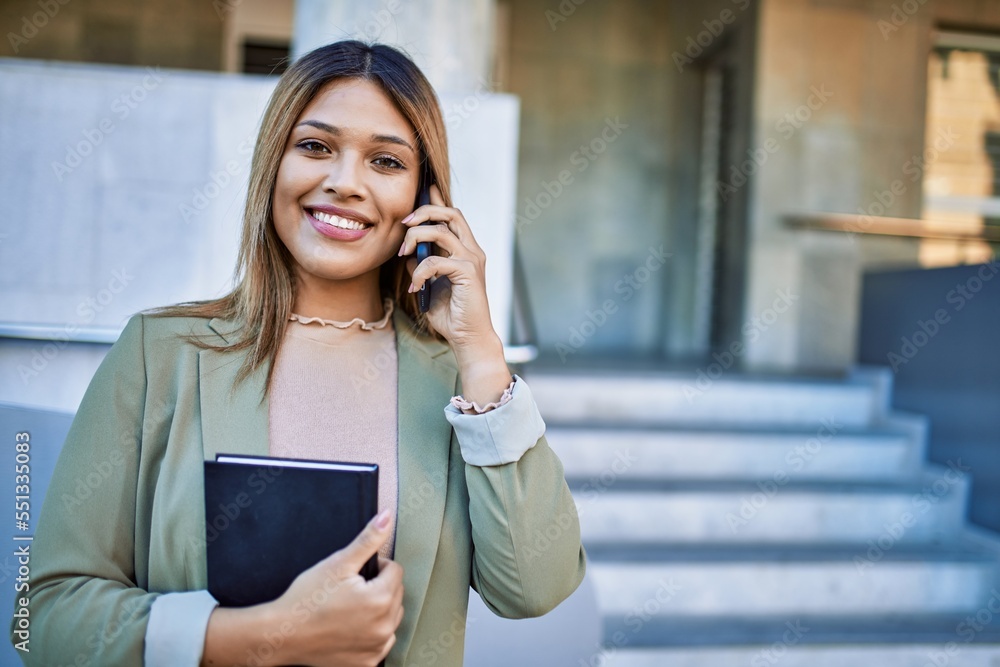 Young latin woman smiling confident talking on the smartphone at street Young latin woman smiling confident talking on the smartphone at street