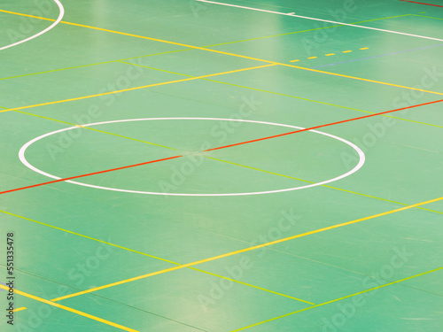 Green floor basketball court  old worn out scratches. Lines on floor