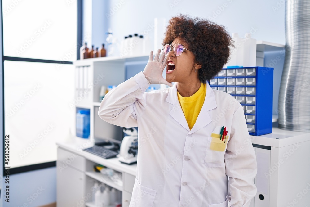 Young african american woman working at scientist laboratory clueless and confused with open arms, no idea and doubtful face. Young african american woman working at scientist laboratory clueless and confused with open arms, no idea and doubtful face.