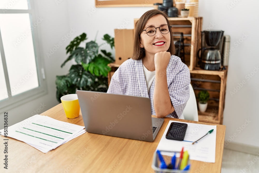 Middle age hispanic woman businesswoman working using laptop at business office Middle age hispanic woman businesswoman working using laptop at business office