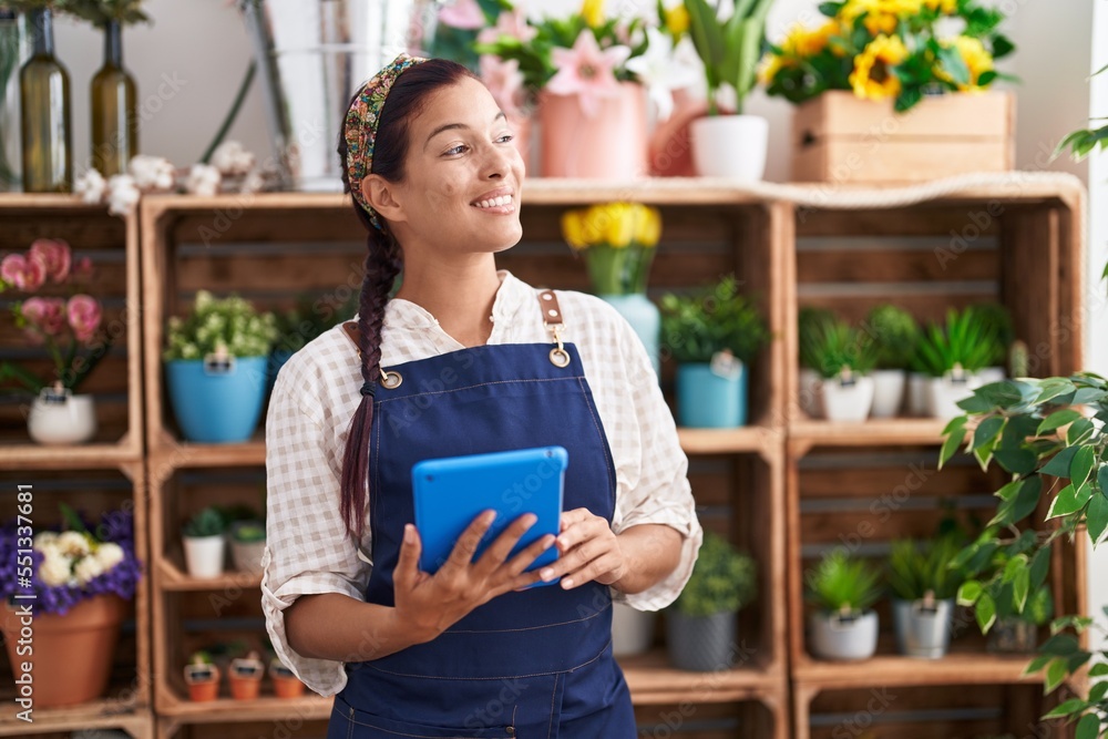 Young beautiful hispanic woman florist smiling confident using touchpad at florist Young beautiful hispanic woman florist smiling confident using touchpad at florist