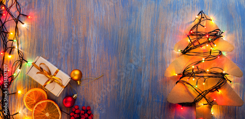 Christmas gift box and illumination decorations on wooden background copy spa...