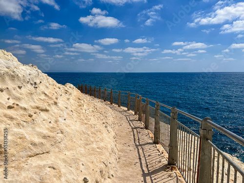 Pathway fenced from sea on ...