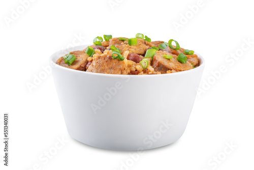 Kidney beans tomato paste sausage rice stew in a bowl on a white isolated background