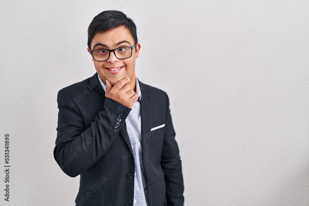 Young hispanic man with down syndrome wearing business style looking confident at the camera smiling with crossed arms and hand raised on chin. thinking positive. Young hispanic man with down syndrome wearing business style looking confident at the camera smiling with crossed arms and hand raised on chin. thinking positive.