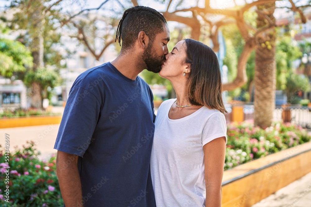 Man and woman couple kissing and hugging each other at park Man and woman couple kissing and hugging each other at park