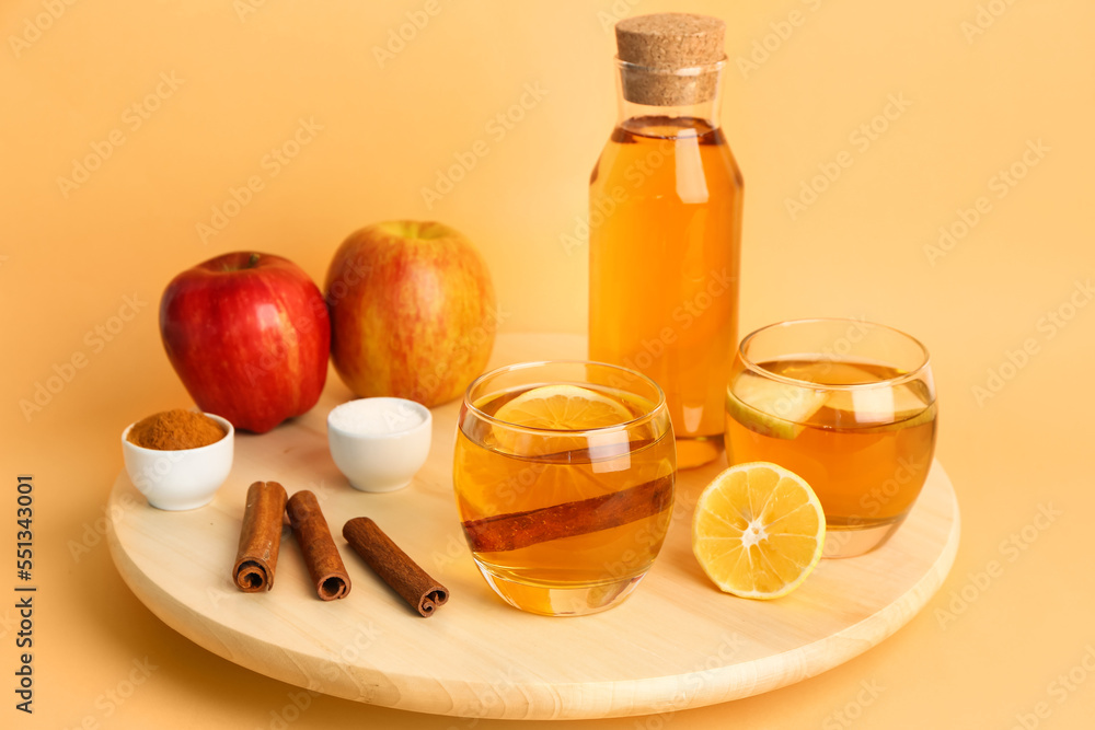 Wooden board with spices, bottle and glasses of fresh apple juice on color background Wooden board with spices, bottle and glasses of fresh apple juice on color background