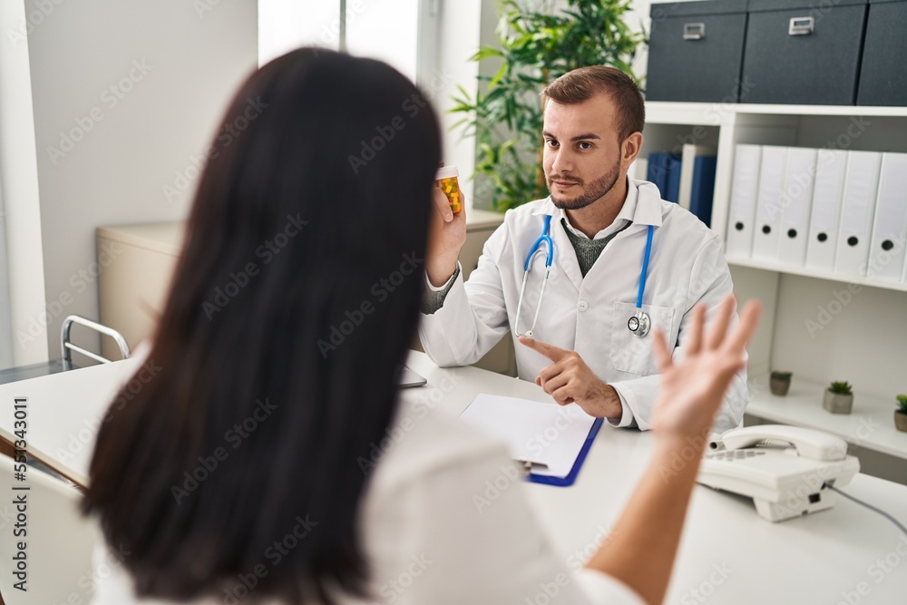 Man and woman doctor and patient having medical consultation prescribe pills at clinic Man and woman doctor and patient having medical consultation prescribe pills at clinic