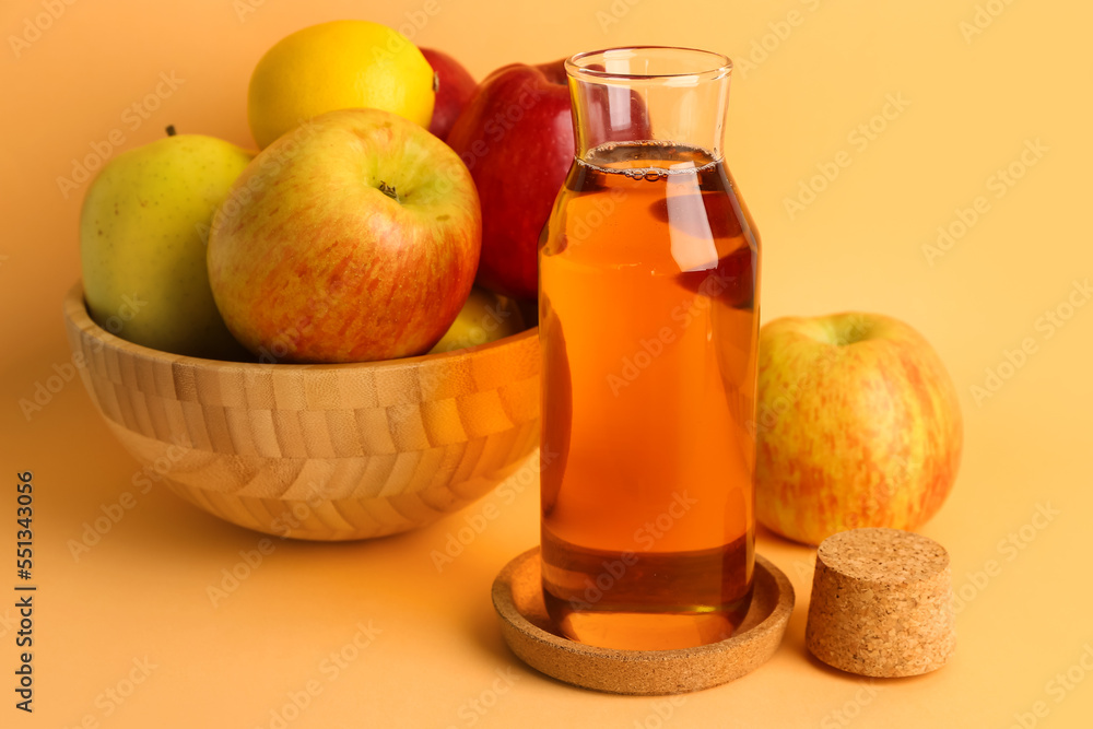 Bowl with ripe apples and bottle of fresh juice on color background Bowl with ripe apples and bottle of fresh juice on color background