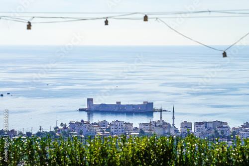 Kız Kalesi in Mersin Turkey with some light bulb cables, and city view to mediterranean sea photo