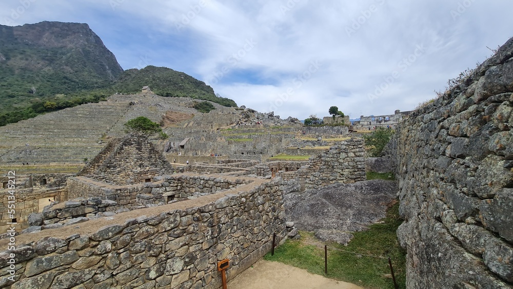 Machu Picchu is a 15th-century Inca citadel located in southern Peru on a 2,430-meter (7,970 ft) mountain ridge. It is located within Urubamba Province above the Sacred Valley, northwest of Cusco.