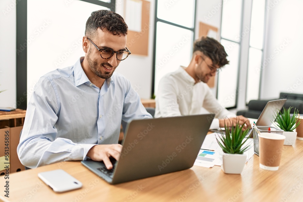 Two hispanic men business workers smiling confident working at office Two hispanic men business workers smiling confident working at office