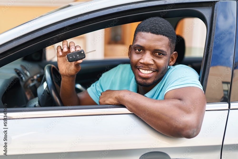 Young african american man smiling confident holding key of new car at street Young african american man smiling confident holding key of new car at street