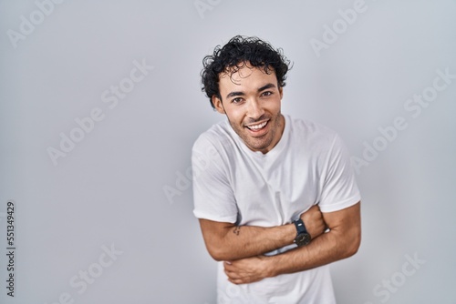 Wallpaper Mural Hispanic man standing over isolated background smiling and laughing hard out loud because funny crazy joke with hands on body. Torontodigital.ca