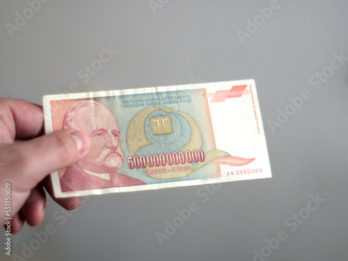 Hand of a person holding a 500000000000 - 500 billion Yugoslav dinars banknote from the period of hyperinflation in 1993 photo