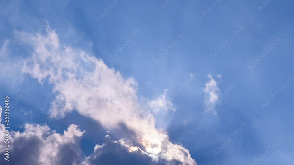 Clouds formation in blue sky with sun rays. Timelapse, fast moving. Fresh air, climate change, weather concept