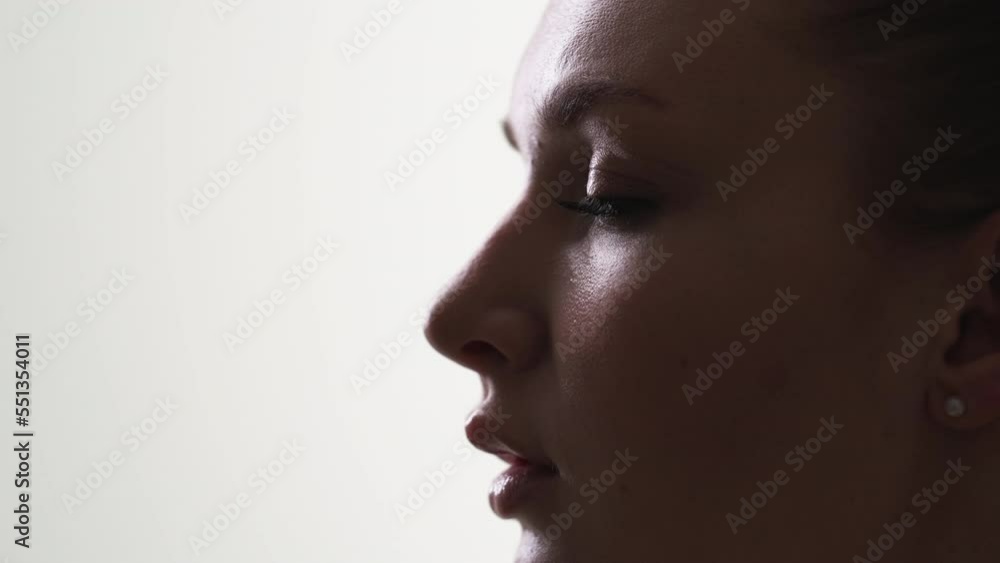 Natural beauty. Female silhouette portrait. Skincare treatment. Sensual pretty woman nude makeup posing on white background copy space slow motion.