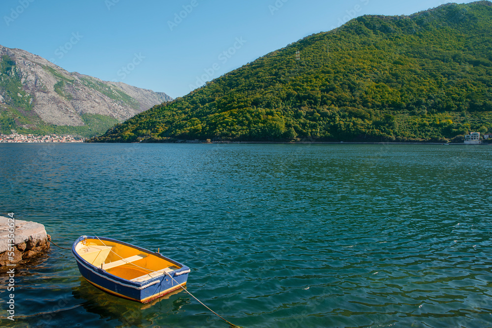 Boat in the Bay of Kotor overlooking the mountains.