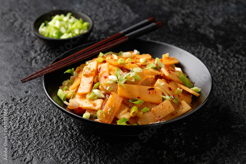 Spicy bamboo shoot salad in black bowl. Asian food