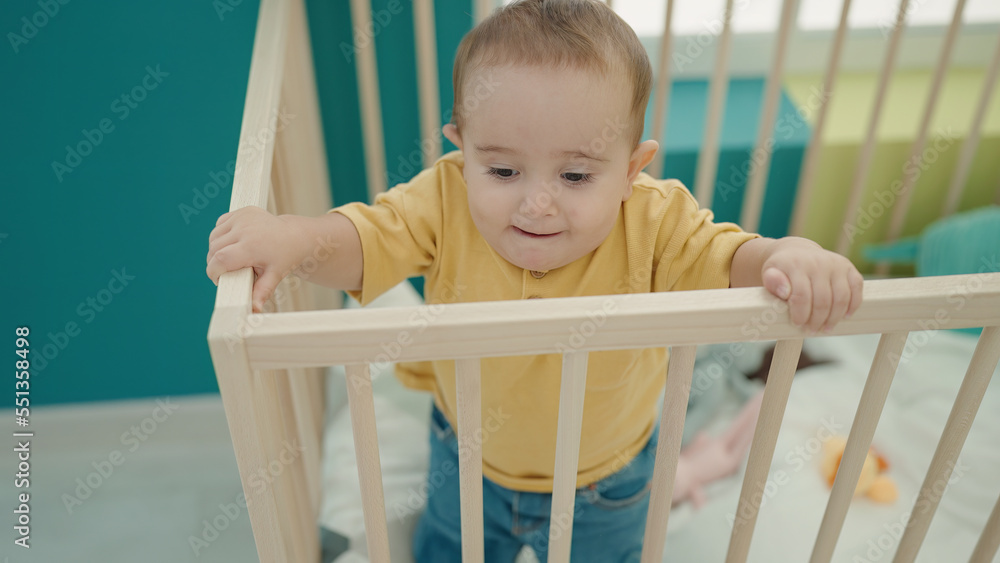Adorable hispanic baby smiling confident standing on cradle at bedroom Adorable hispanic baby smiling confident standing on cradle at bedroom