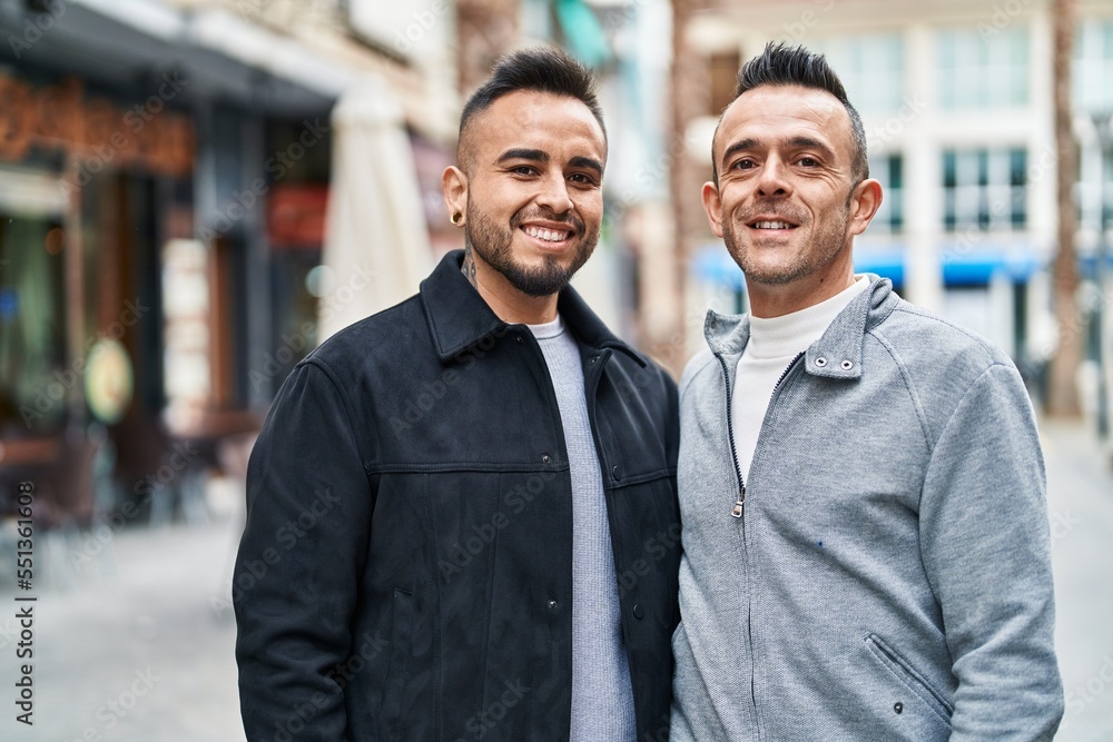 Two men couple smiling confident standing together at street Two men couple smiling confident standing together at street