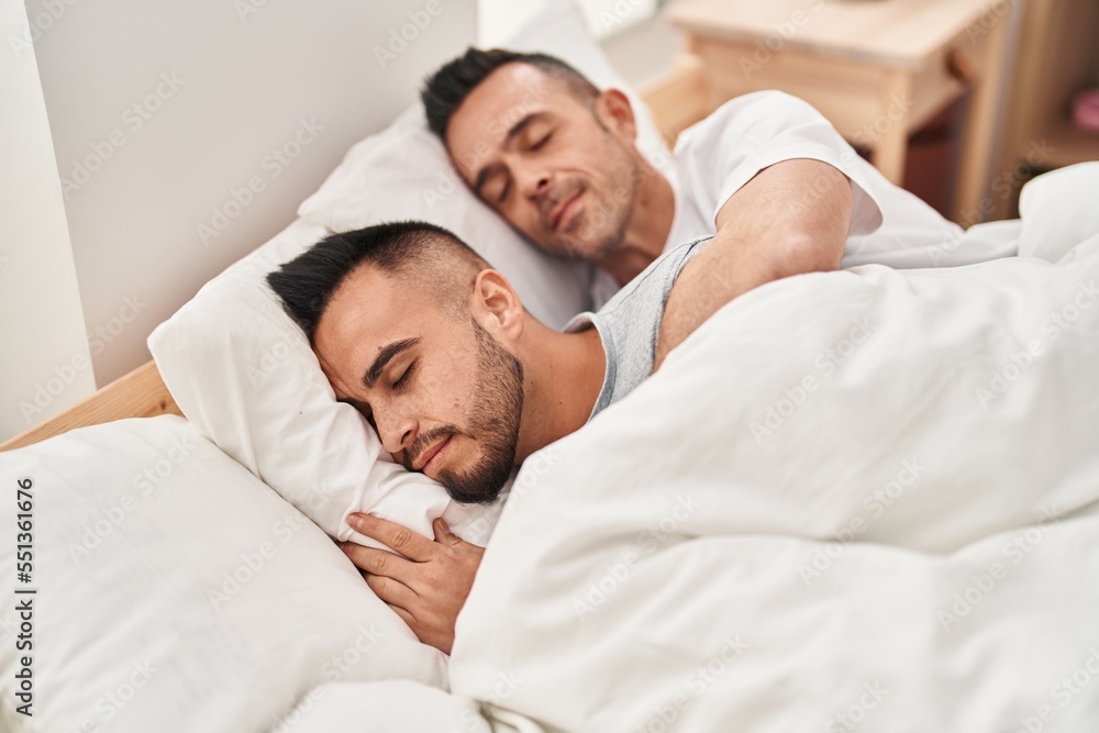Two men couple lying on bed sleeping at bedroom Two men couple lying on bed sleeping at bedroom