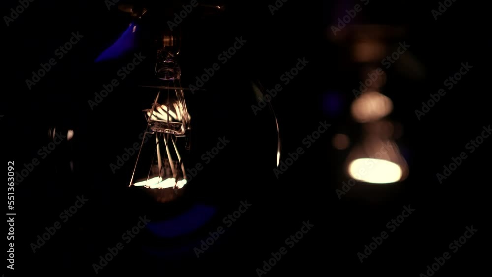 Two light bulbs in the dark light up and go out. Tesla light bulb. Electricity Close-up. Energy system, light, blackout. Two light bulbs in the dark light up and go out. Tesla light bulb. Electricity Close-up. Energy system, light, blackout.