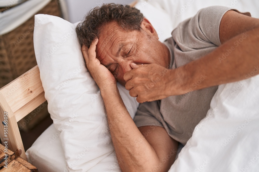 Middle age man lying on bed sleeping at bedroom Middle age man lying on bed sleeping at bedroom