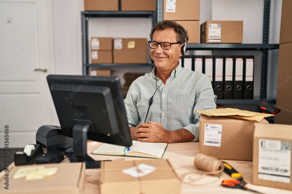 Senior man working at small business ecommerce wearing headset with a happy and cool smile on face. lucky person. Senior man working at small business ecommerce wearing headset with a happy and cool smile on face. lucky person.