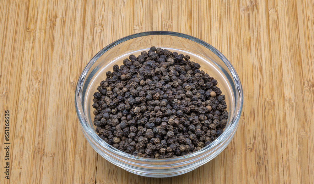 Black pepper closeup on wooden background Black pepper closeup on wooden background