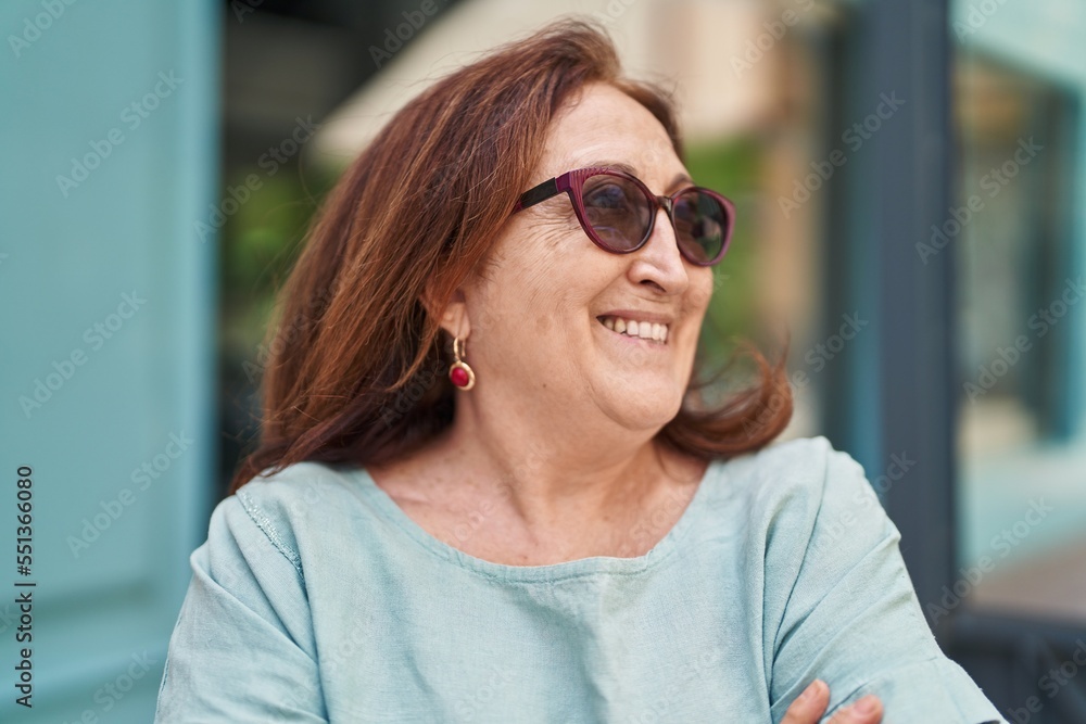 Senior woman smiling confident looking to the side at street Senior woman smiling confident looking to the side at street