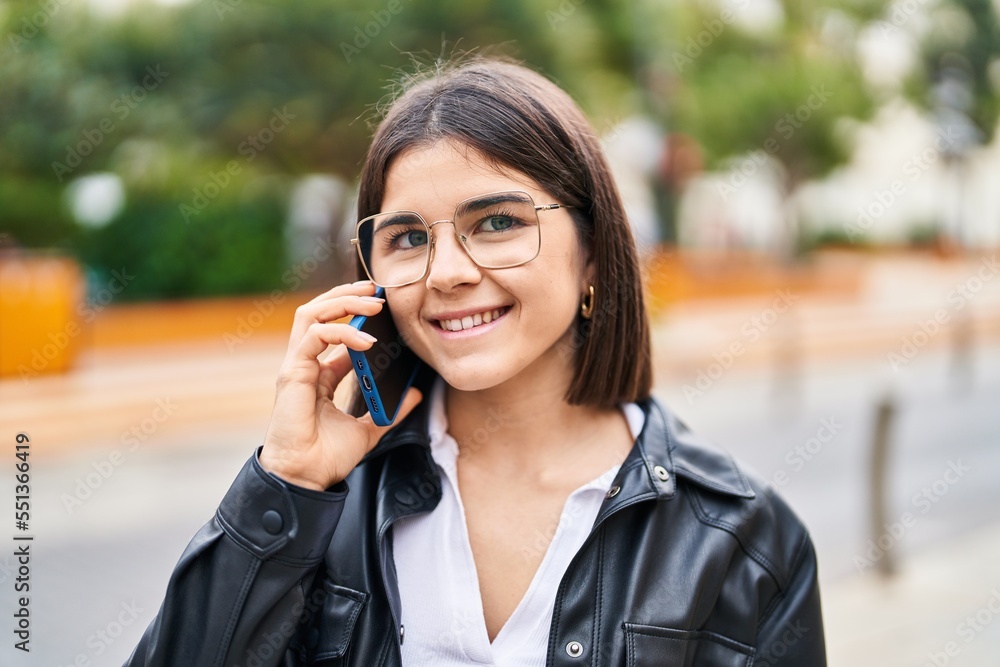 Young beautiful hispanic woman smiling confident talking on the smartphone at street Young beautiful hispanic woman smiling confident talking on the smartphone at street