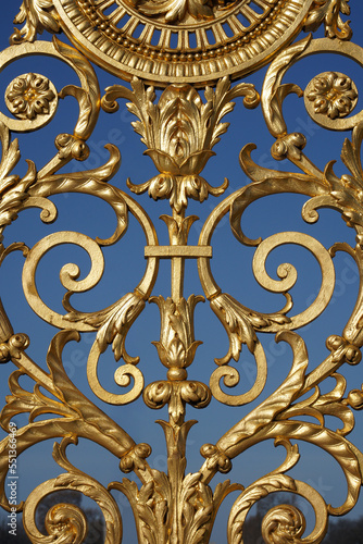 Motifs of details of an Imperial golden gate on blue sky.