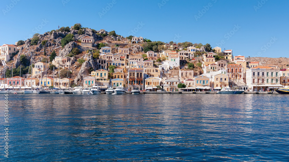 Colored houses on the embankment of Symi island, Greece.