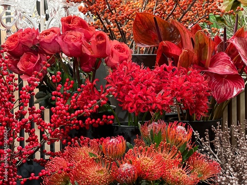 Bouquets flowers red pink roses, protea, anthurium, guernsey lily nerine , ornamental berries in flower shop. photo