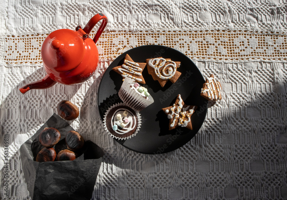 Roasted chestnuts and tea with ginger cookies and sweets for Christmas