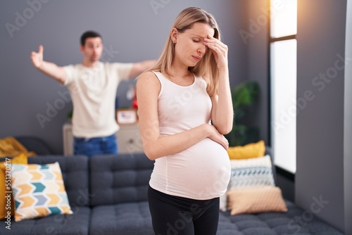 Man and woman couple expecting baby arguing at home