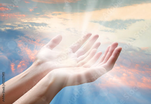 The outstretched hands of a praying man