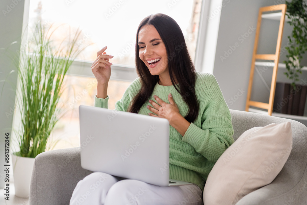 Photo of cheerful positive lady use blogger speaking friends followers modern netbook device relax rest sit cozy chair home workspace