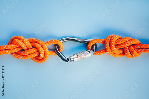 Grey carbine with clutch. Equipment for climbing and mountaineering. Safety rope. Knot eight