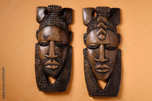 Old wooden African masks on an orange background