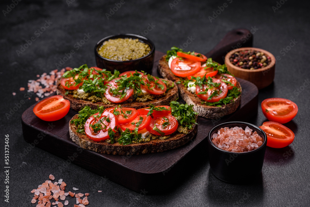 Tasty bruschetta with tomatoes, mozzarella, basil, spices and herbs Tasty bruschetta with tomatoes, mozzarella, basil, spices and herbs