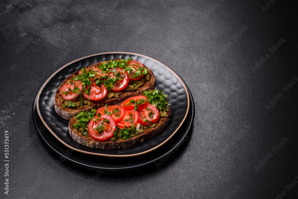 Tasty bruschetta with tomatoes, mozzarella, basil, spices and herbs Tasty bruschetta with tomatoes, mozzarella, basil, spices and herbs