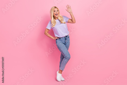Full length photo of astonished glad person arm palm waving greeting isolated on pink color background