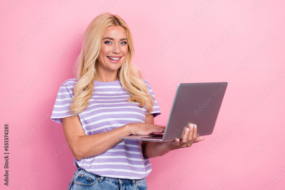 Photo of pretty lovely lady use macbook netbook quality gadget empty space isolated on pink color background Photo of pretty lovely lady use macbook netbook quality gadget empty space isolated on pink color background