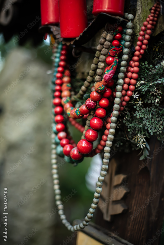 Folk red and green beads on a green column